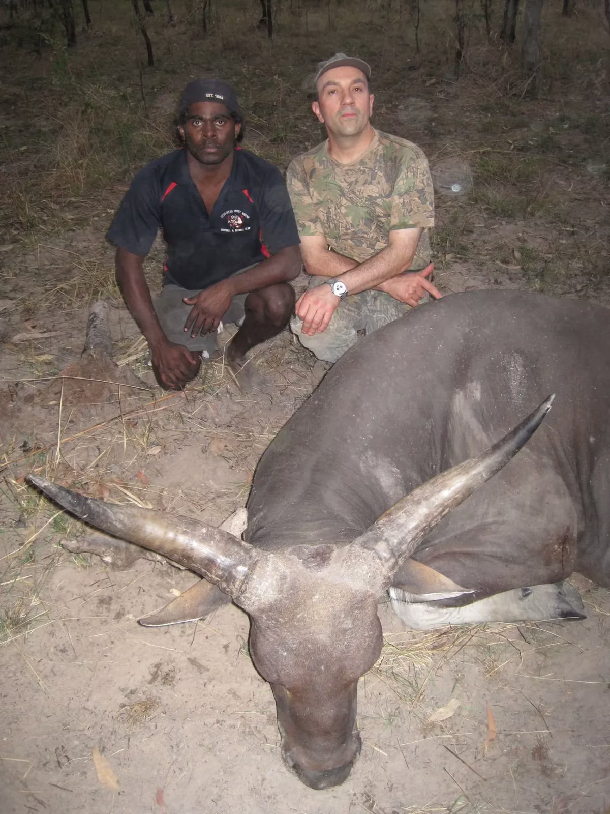 Guide and hunter with a banteng bull taken at dusk