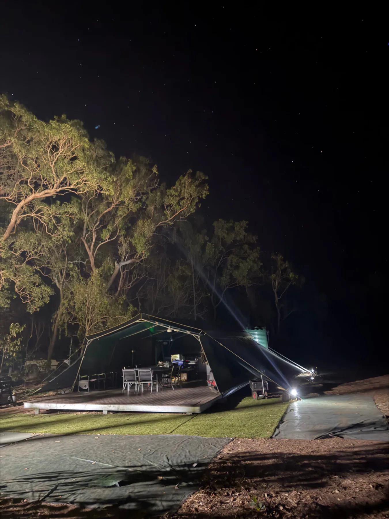 Camp mess deck lit up under a night sky